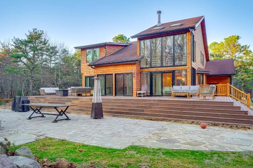 a large wooden house with a large deck at Ski, Hike and More Spacious Log Cabin in Long Pond in Long Pond