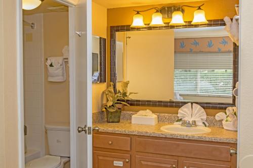 a bathroom with a sink and a mirror at Westgate Leisure Resort in Orlando