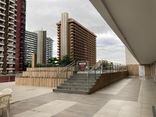 a balcony with stairs in a city with buildings at Garvey Park Hotel in Brasilia