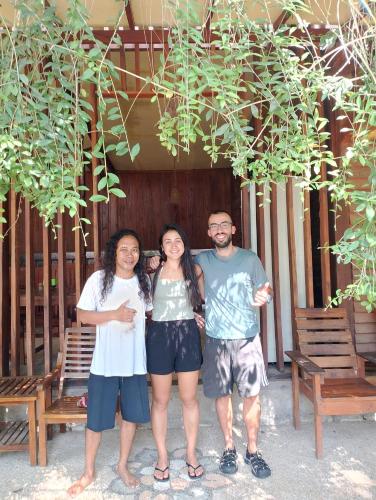 a group of three people posing for a picture at Awang Bungalows And Restaurants in Awang