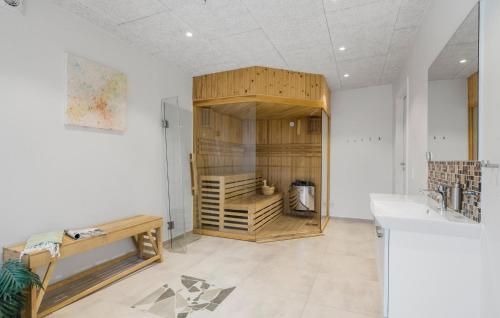 a room with a wooden closet with a sink at 5 Bedroom Amazing Home In Herning in Herning
