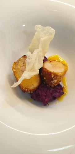 a white plate with a piece of food on it at Il Castagneto Hotel in Melfi