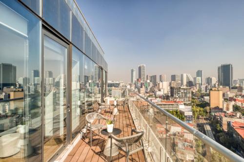 a balcony with a view of the city at ULIV Mexico City in Mexico City