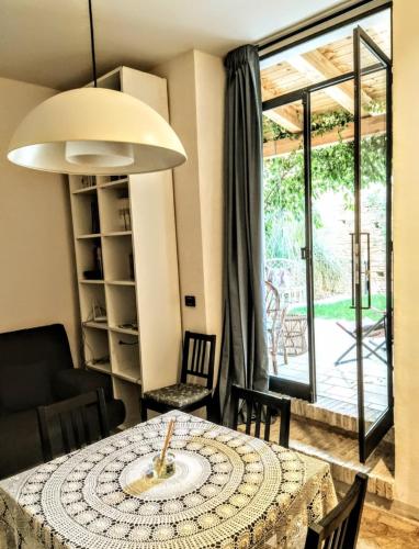 a dining room with a table and chairs and a window at Casa Corte - Le Bouganville B&B in Lucera