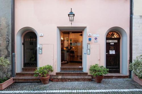 an entrance to a building with two doors and stairs at Mondo Antico B&B in Cesena
