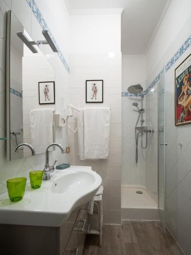 a white bathroom with a sink and a shower at Mondo Antico B&B in Cesena