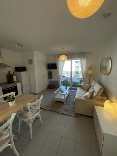 un salon avec un canapé et une table dans l'établissement Appartement neuf, parking et terrasse Proche Vélodrome, à Marseille