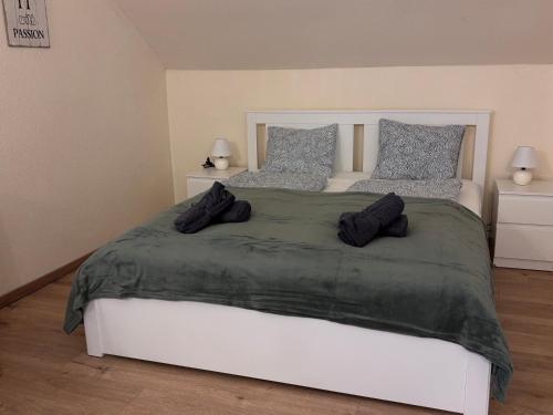 a bedroom with a large bed with two pillows at AIRPORTMAX Panzió in Vecsés