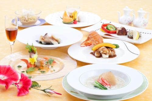 a table topped with plates of food and drinks at Koriyama View Hotel in Koriyama