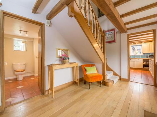 a bathroom with a staircase and a toilet at Bearwood House in Pembridge