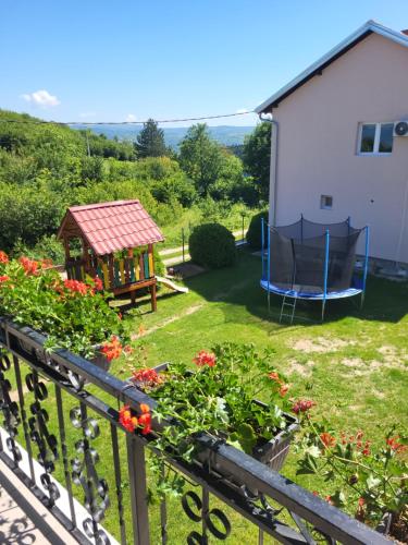 a garden with a gazebo and flowers at Apartment Pavlovic in Soko Banja