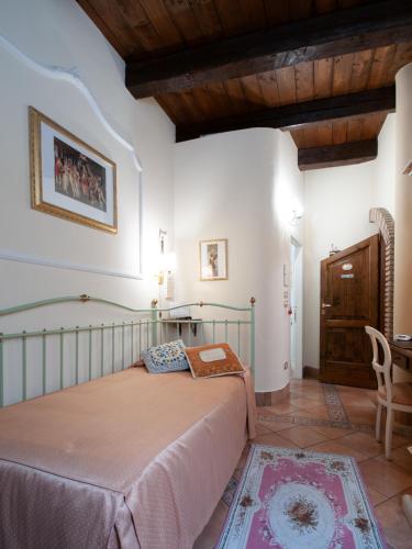 a bedroom with a bed and a table in a room at Mondo Antico B&B in Cesena