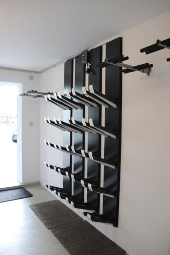a black wine rack on the wall of a room at Appartements Marktplatzerl in Mauterndorf