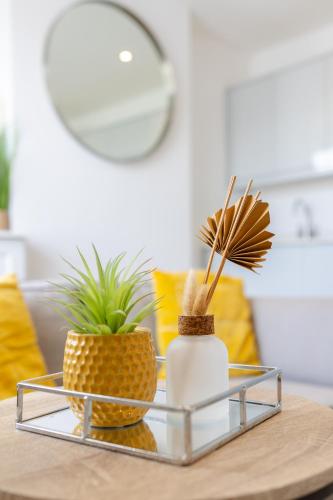 a coffee table with two pineapple vases on it at Boutique City Centre Apartments in Cardiff