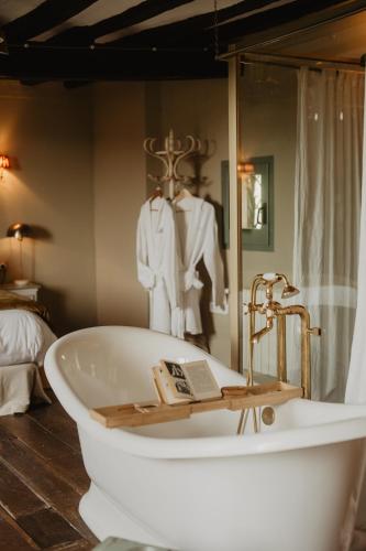 a bath tub in a room with a mannequin at Mas el Mir in Ripoll