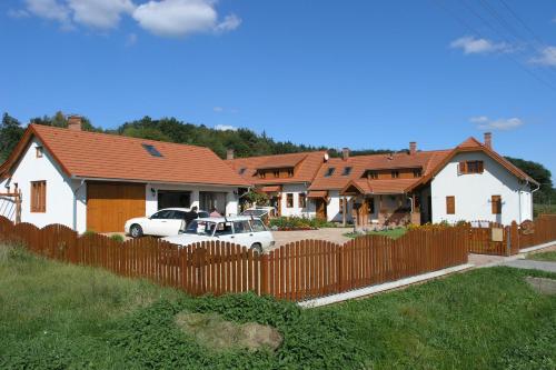 a white car parked in front of a house at Faluszéli Vendégház - Boncz Porta in Nagyrákos