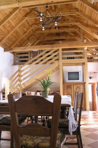 a dining room with a table and chairs and a tv at Faluszéli Vendégház - Boncz Porta in Nagyrákos
