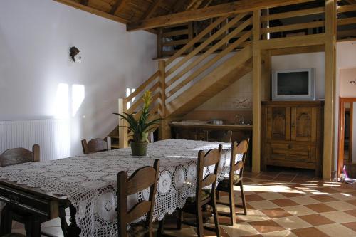 a dining room with a table and chairs and a television at Faluszéli Vendégház - Boncz Porta in Nagyrákos