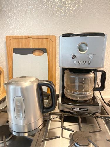 a coffee maker sitting on top of a stove at Cozy Guest Rooms Near UBC, Downtown and Beaches in Vancouver