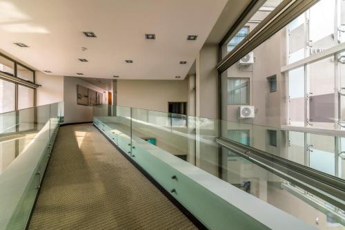 an empty hallway in a building with glass floors at Hotel Los Españoles Plus in Santiago