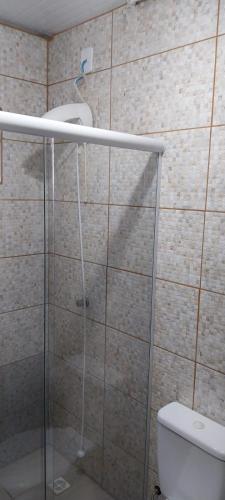 a bathroom with a shower with a toilet and a sink at Morada Sol e Lua Container Guarda do Embaú com Ar condicionado in Guarda do Embaú