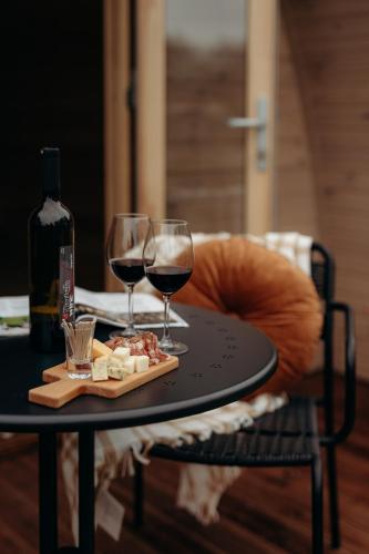 a table with two glasses of wine and cheese at Parcpod Kapèlkeshof in Grashoek