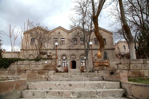 an old stone building with stairs in front of it at Karballa Hotel in Aksaray