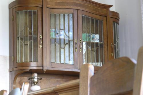 a wooden cabinet with stained glass windows on it at Faluszéli Vendégház - Boncz Porta in Nagyrákos