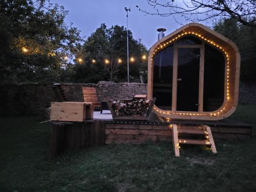 a large mirror with lights in a yard at night at Gîte BARD des OURS in Saint-Martin-en-Vercors
