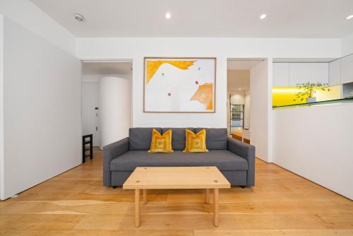 a living room with a couch and a coffee table at Oxford Circus Designer Apartment in London