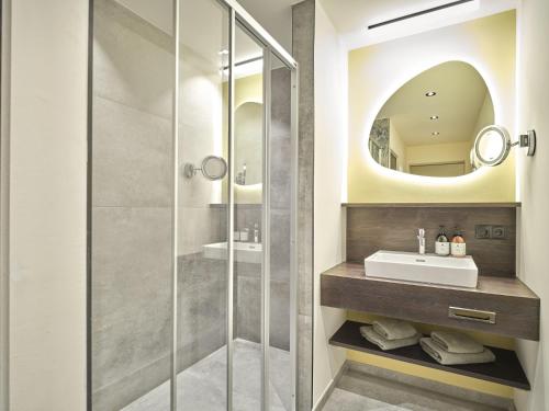 a bathroom with a sink and a shower at Hotel Matschner in Ramsau am Dachstein