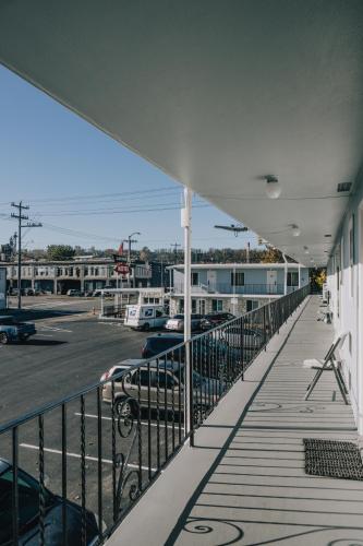 a balcony of a building with a parking lot at La Hacienda Motel in Seattle
