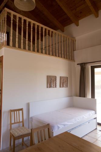 a bedroom with a bed and a chair at 5 Stars Villas in Svoronata