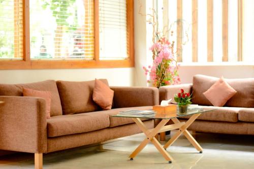 a living room with a couch and a table at PINE LODGE MALDIVES in Hulhumale