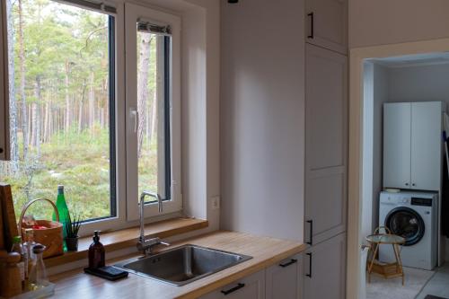 a kitchen with a sink and a window at Rooslepa seaside getaway in Rooslepa