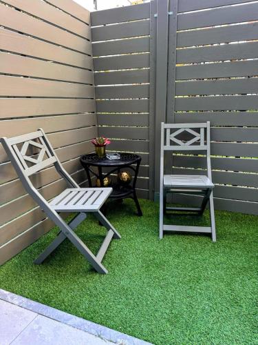 two chairs and a table on a patio at WARSZAWA CENTRAL HOUSE - Studios in Warsaw with Private Jacuzzi, full access to Sauna, Gym and Billards - Studia z prywatnym Jacuzzi oraz dostępem do sauny, siłowni i bilarda in Warsaw
