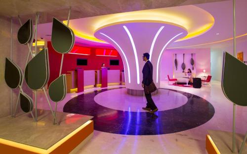 a man in a suit walking in a room at ibis Chennai City Centre - An Accor Brand in Chennai