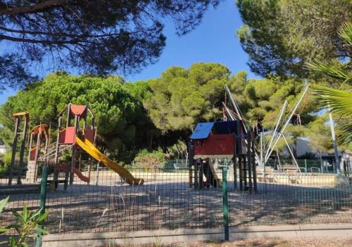 a playground with two slides and a slide at Mobile Home 450 4-6 pers Camping Siblu Le Lac des Rêves in Lattes