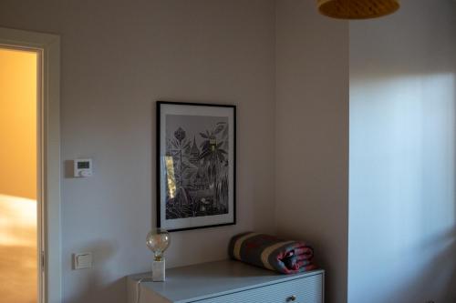 a room with a picture on the wall and a dresser at Rooslepa seaside getaway in Rooslepa