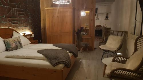 a bedroom with a bed and a living room at Hostellerie Les Bagenelles in Sainte-Marie-aux-Mines