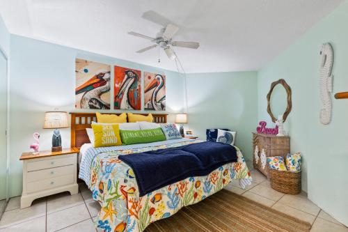 a bedroom with a bed and a ceiling fan at "Summer Winds" at Sunglow Resorts with Spectacular Ocean Views in Daytona Beach Shores