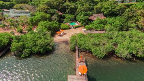 an aerial view of a house next to a river at Hotel Playa Scondida Barú in Baru