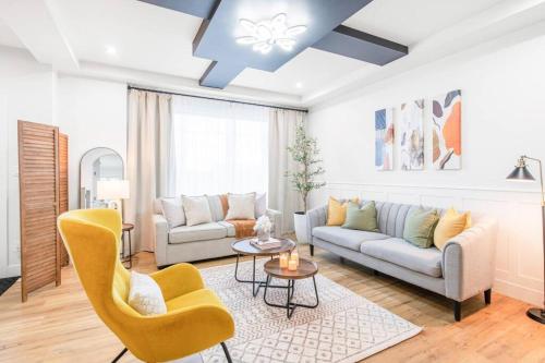 a living room with a couch and a table at Luxury Family Home - Sleeps 10 - King Bed in Nisku