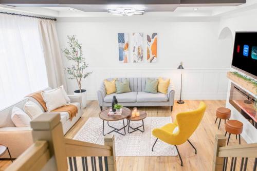 a living room with a couch and a table at Luxury Family Home - Sleeps 10 - King Bed in Nisku