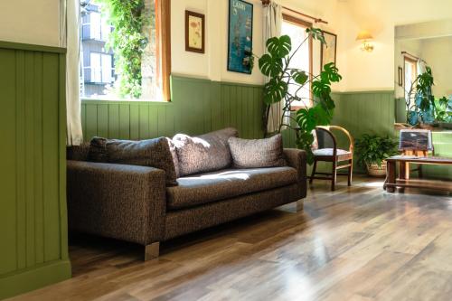 a living room with a couch and some plants at Hotel Turismo in San Martín de los Andes