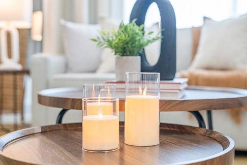 two candles sitting on a table in a living room at Luxury Family Home - Sleeps 10 - King Bed in Nisku