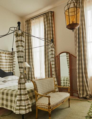 a bedroom with a bed and a lamp and a chair at Hotel Peter and Paul, an Ash Hotel in New Orleans