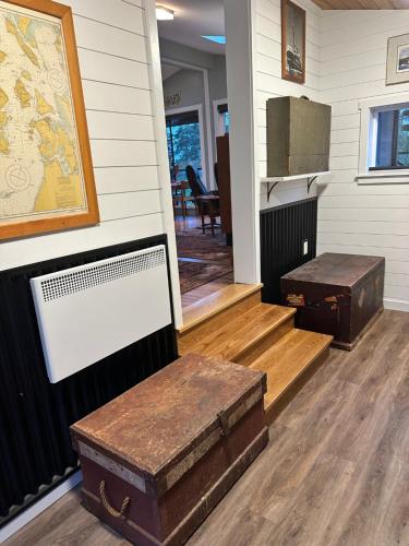 a room with two trunks on the floor and a table at Eagle Way in Port Renfrew