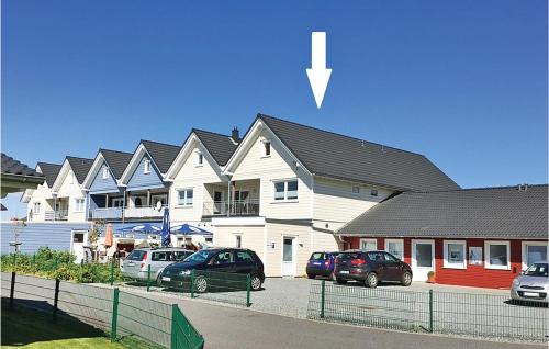 a row of houses with cars parked in a parking lot at Lovely Apartment In Dagebüll With Sauna in Dagebüll
