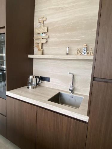 a kitchen with a sink and a counter top at Maison Impression vakantiehuis in Middelkerke